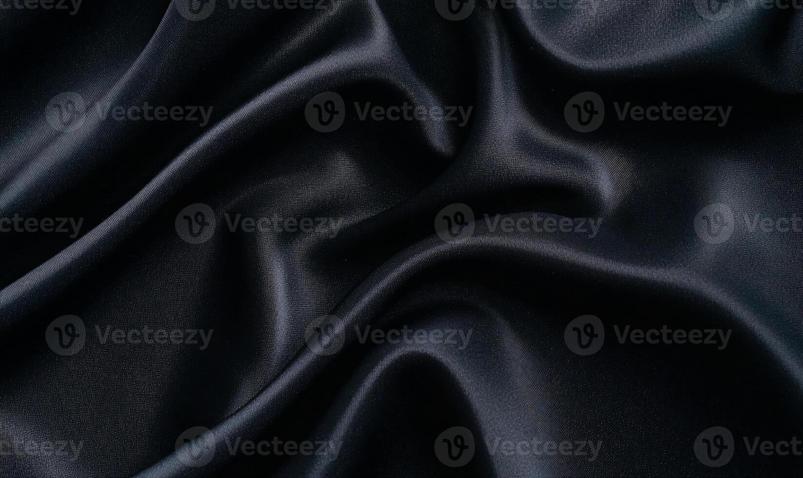 Dark, luxurious fabric with flowing, elegant drapes and soft sheen photo
