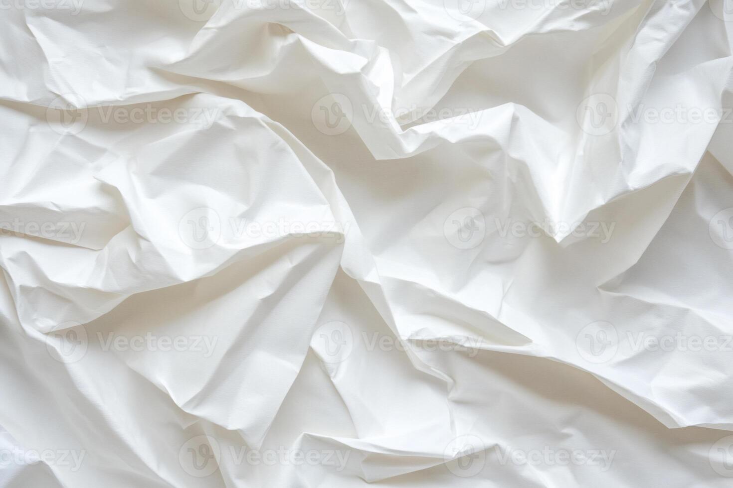 Draped white fabric with soft, flowing folds and creases photo