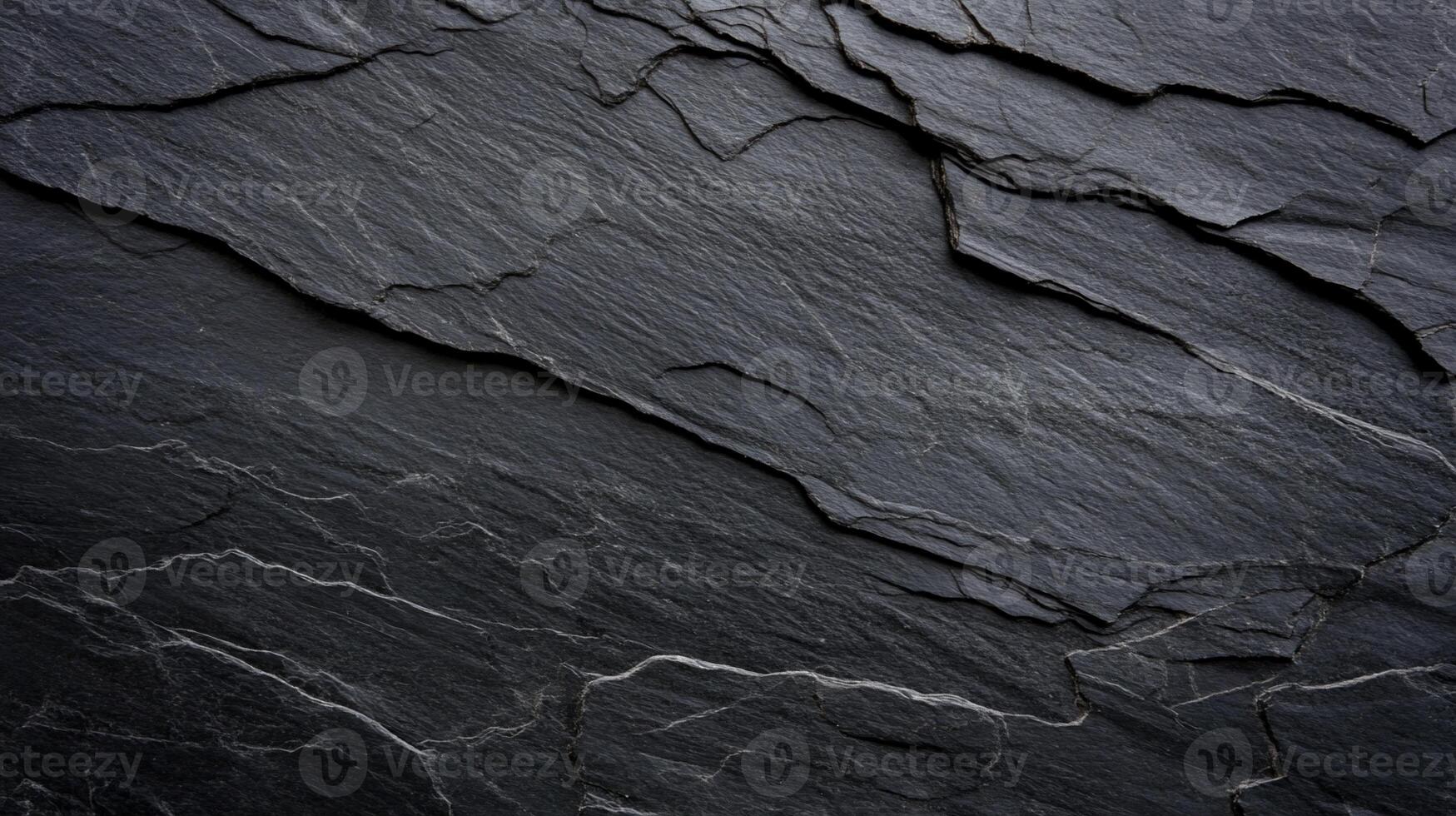 Dark gray slate texture with layered, rough surface photo