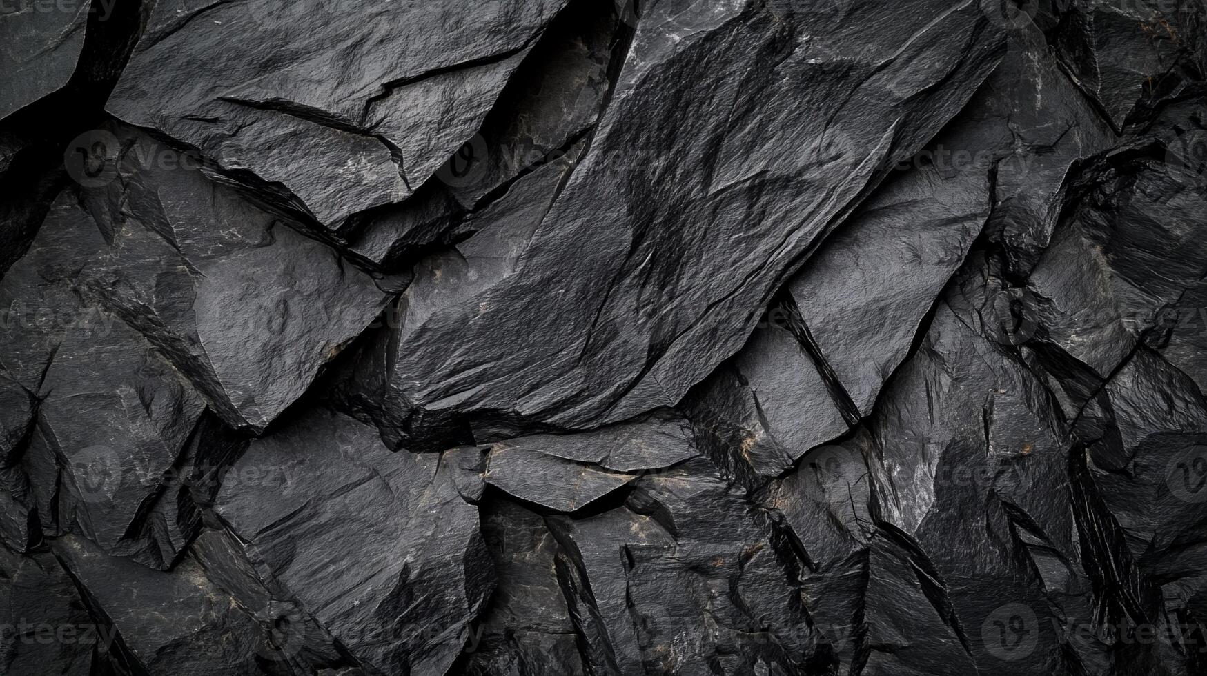 A black rock wall with many different shapes photo
