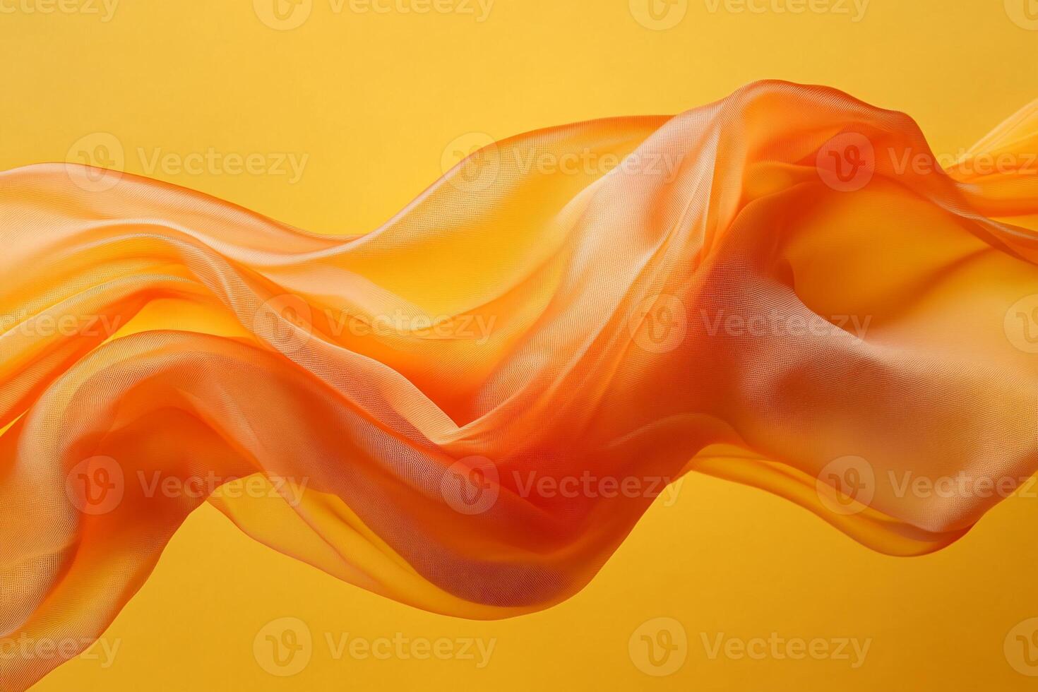 Flowing, orange sheer fabric drapes beautifully against a vibrant backdrop photo