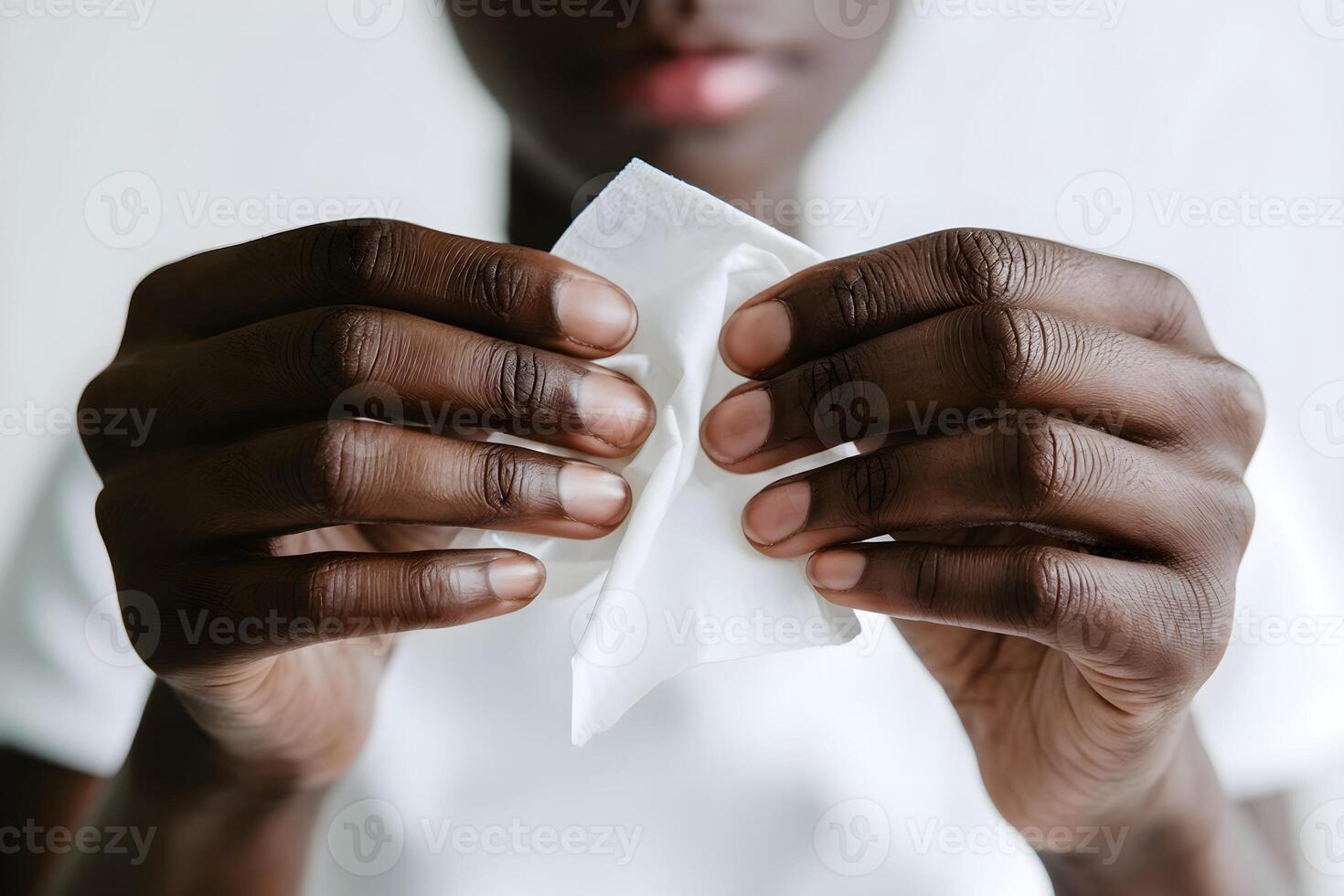 Hands crumpling tissue, focused cleanliness against white background photo