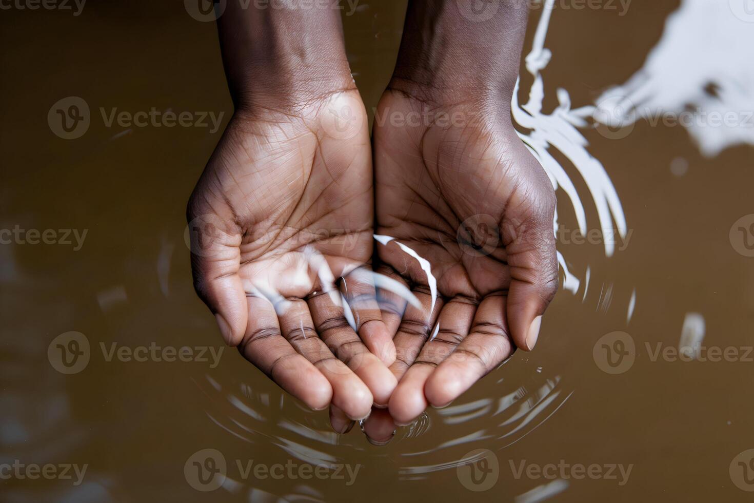 Hands hold clear liquid against a brown background, emphasizing freshness and purity photo