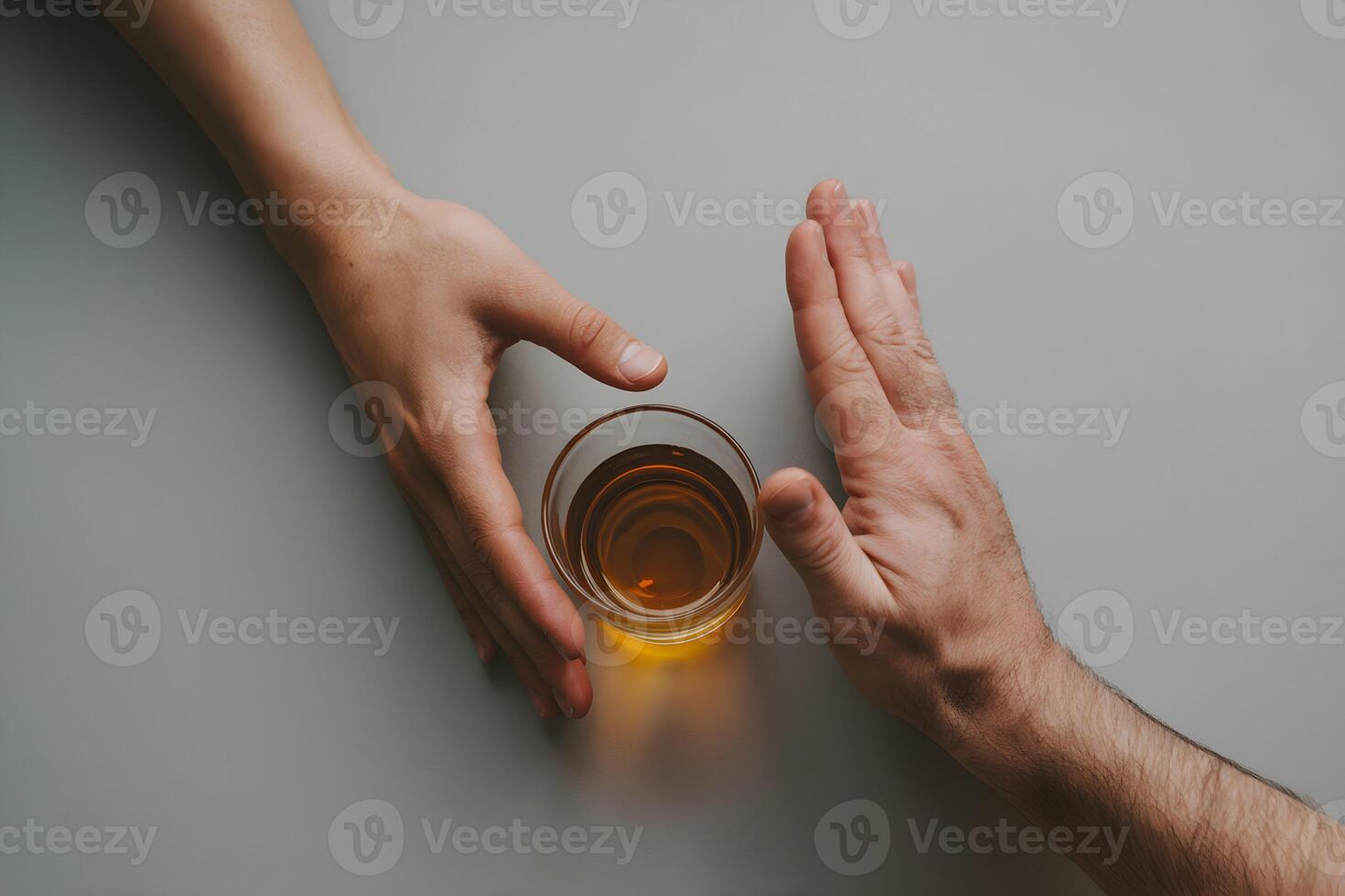 Hands interact with whiskey glass and refusal gesture, symbolizing choice and resistance photo
