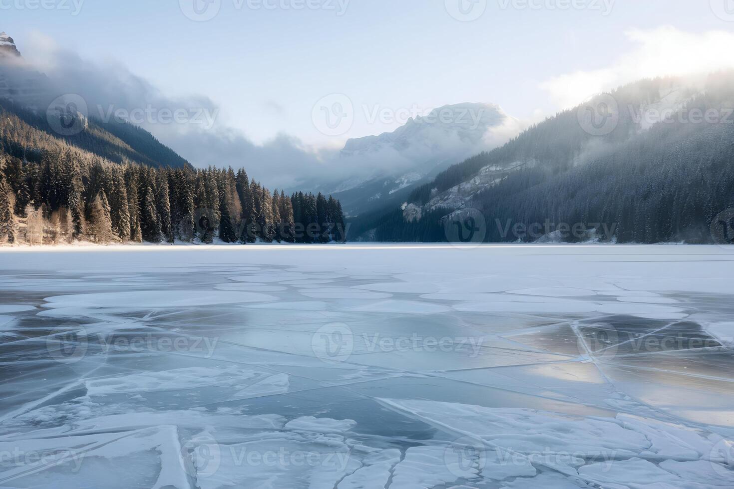Frozen lake with intricate ice patterns, surrounded by snowy trees photo