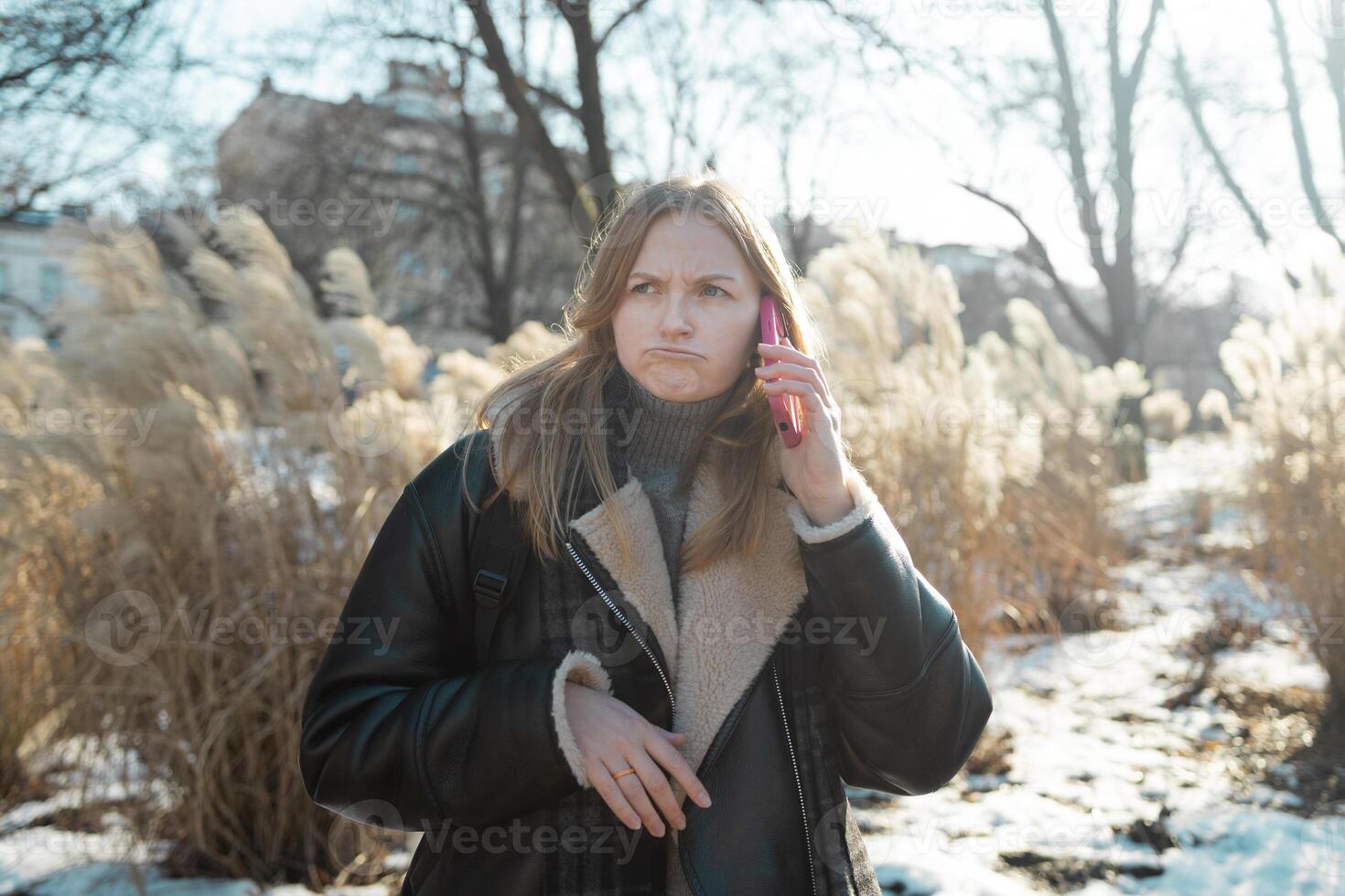 Young angry tired woman talking on the phone stressed with sad face, shocked with shame and fear face, frustrated. Fear and upset. photo
