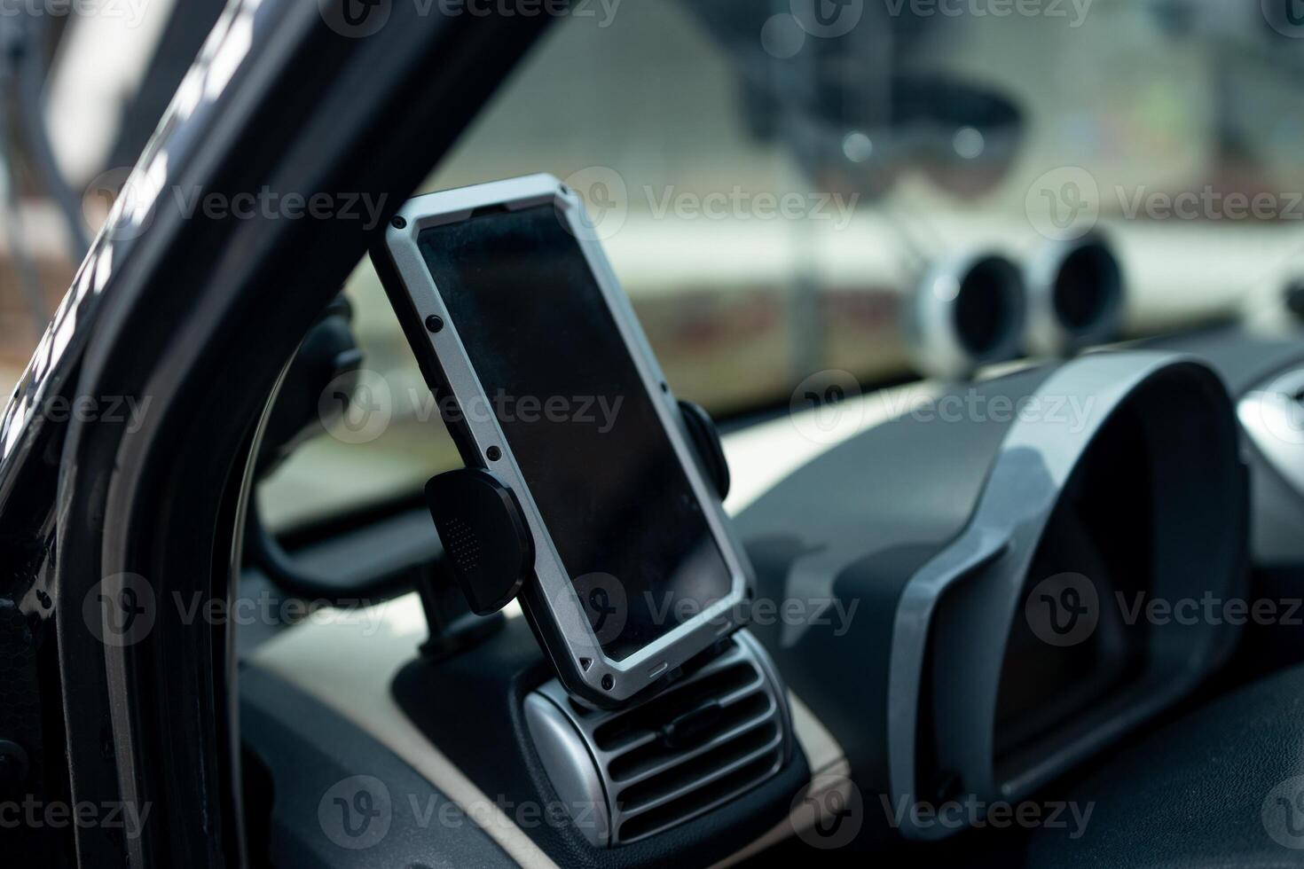 Modern smartphone device gadget mounted on phone holder at car dashboard. Mock-up white screen isolated template. Copyspace for text . Vehicle interior cockpit view. Traffi jam info app photo