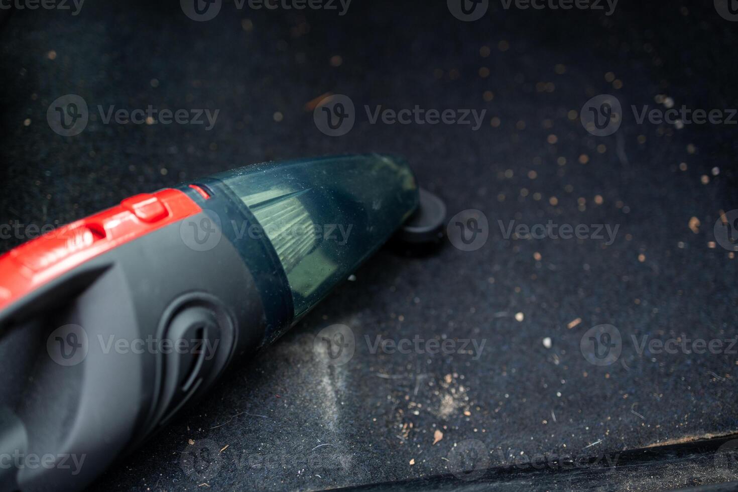 Cleaning the interior of the car with a vehicle vacuum cleaner. photo