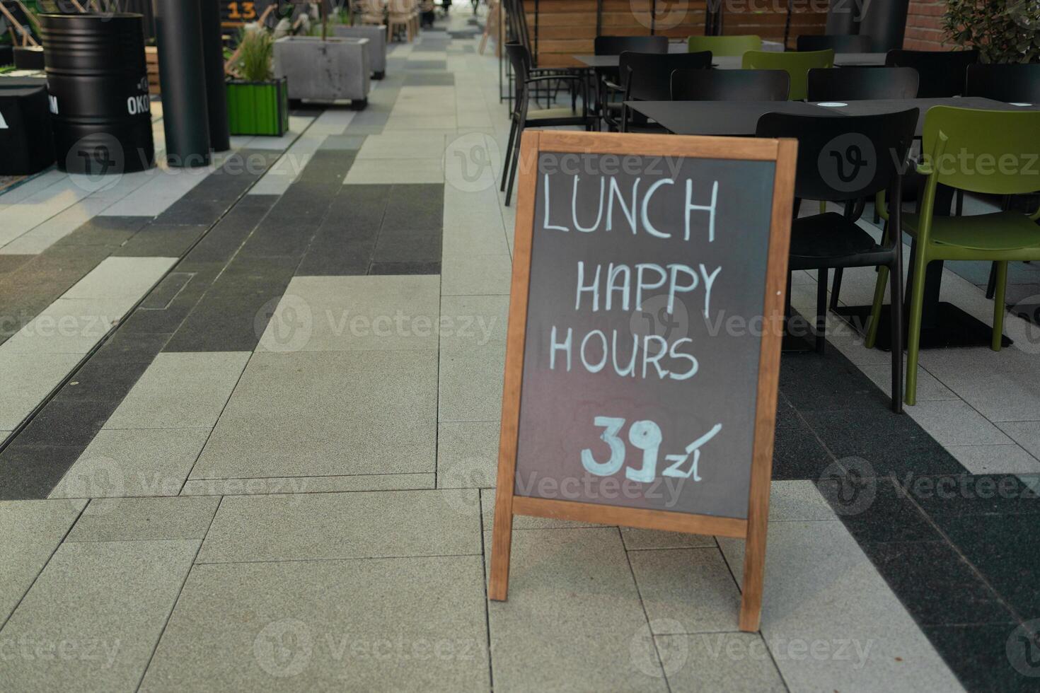 Cafe menu on black board outdoor. Wooden board with text lunch happy hours in city cafe outdoor in Krakow, Poland photo