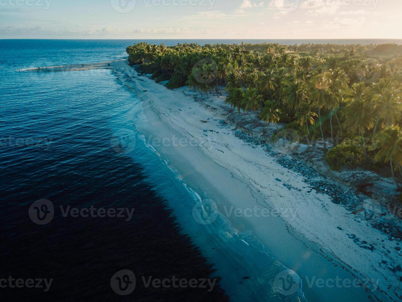 Maldives island with beach and sunrise or sunset. Aerial view of ocean coastline on Fuvahmulah island photo