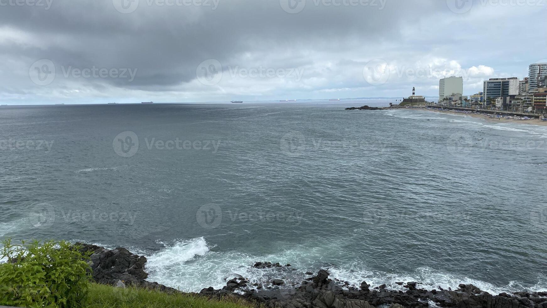 ocean waves cloudy lighthouse photo