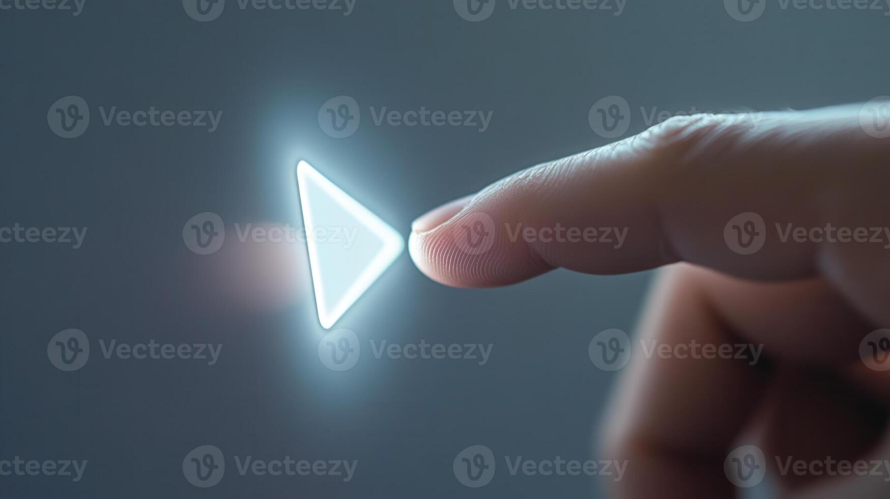 Finger touching glowing play button starting playback photo