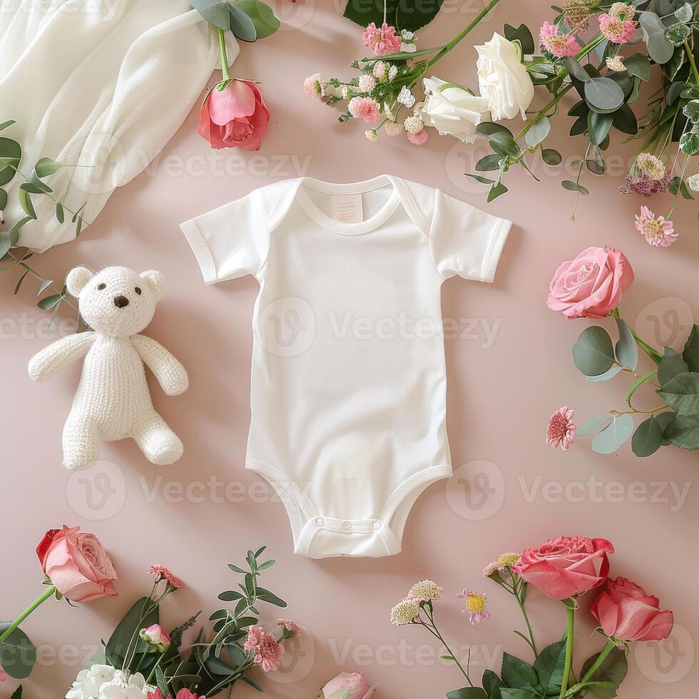 A teddy bear and a baby bodysuit surrounded by flowers photo