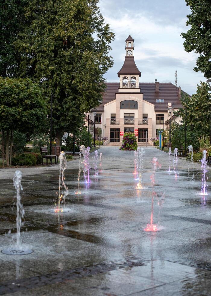 Mikhailowo, Poland, 08.18. 2024. Central city park, fountain, town hall photo
