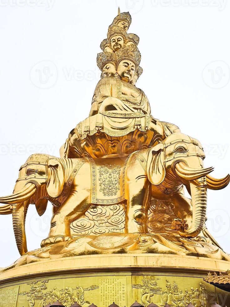 a golden statue of a buddha on top of a building photo