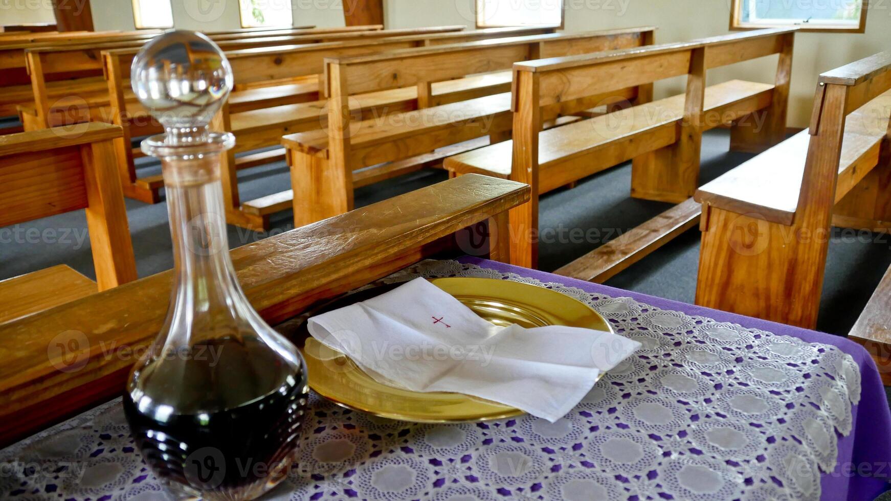 a church with empty pews and a wine bottle photo