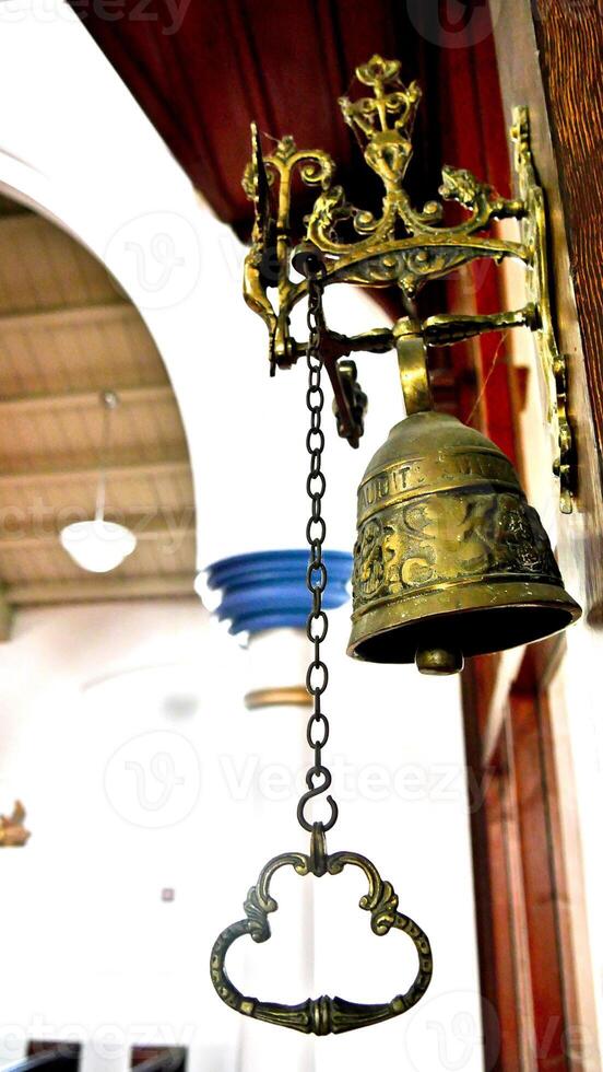 a bell hanging from a wall in a church photo