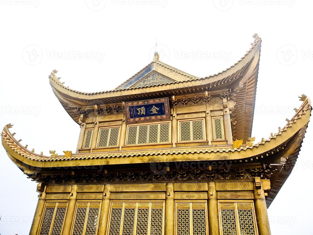 a golden pagoda with a chinese writing on it photo