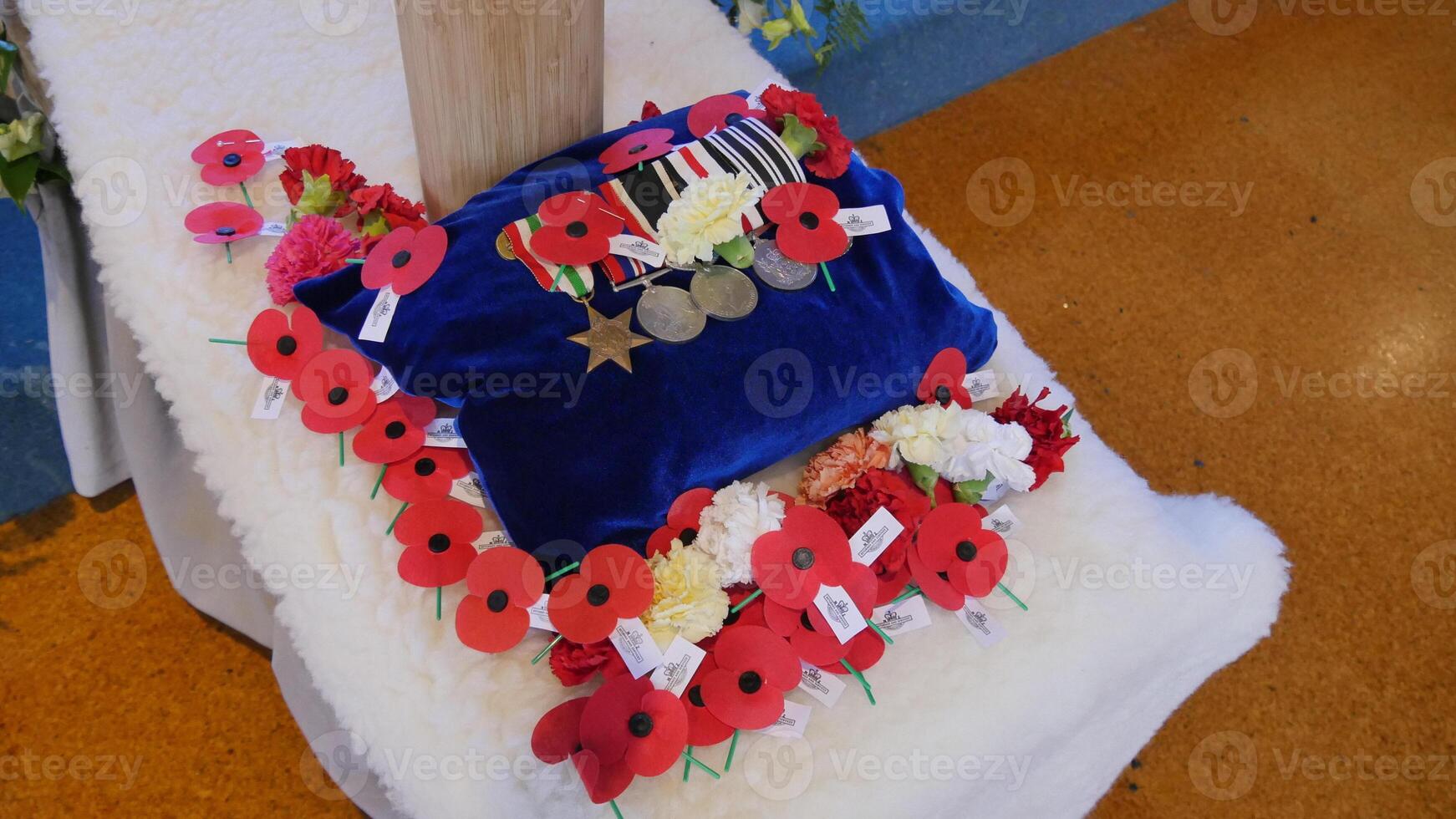 a blue pillow with flowers and a medal on it photo