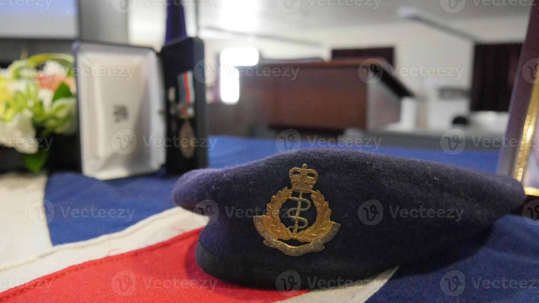 a hat sits on a table with a picture frame photo