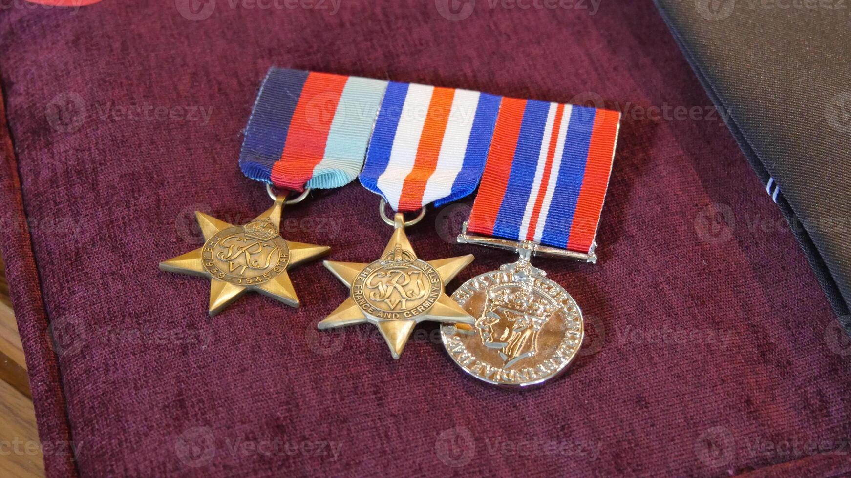three medals are on a purple velvet case photo