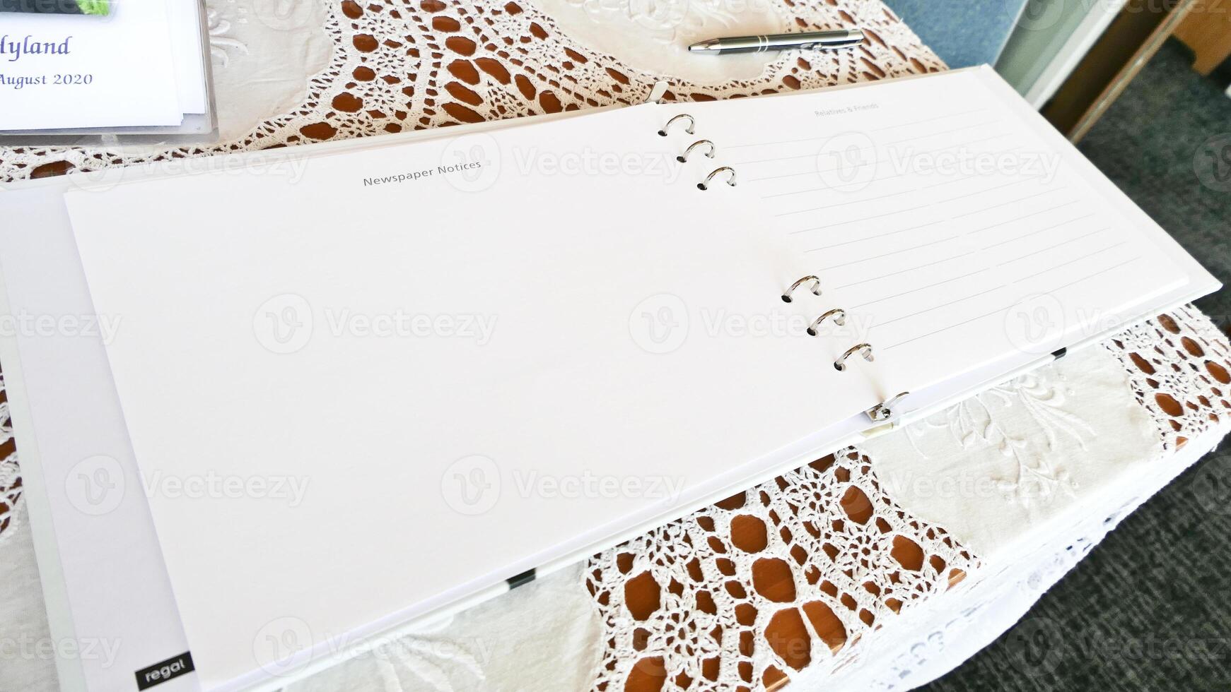 a notebook with a pen and a pen on a table photo