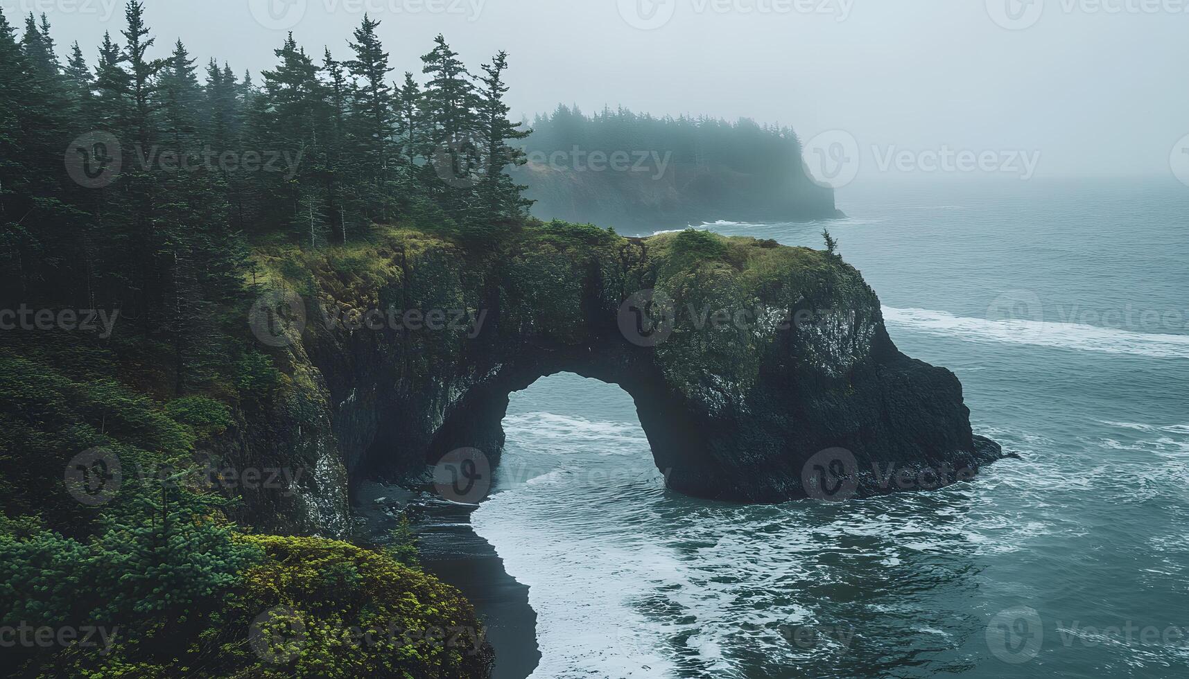 A large rock formation on the ocean shore photo