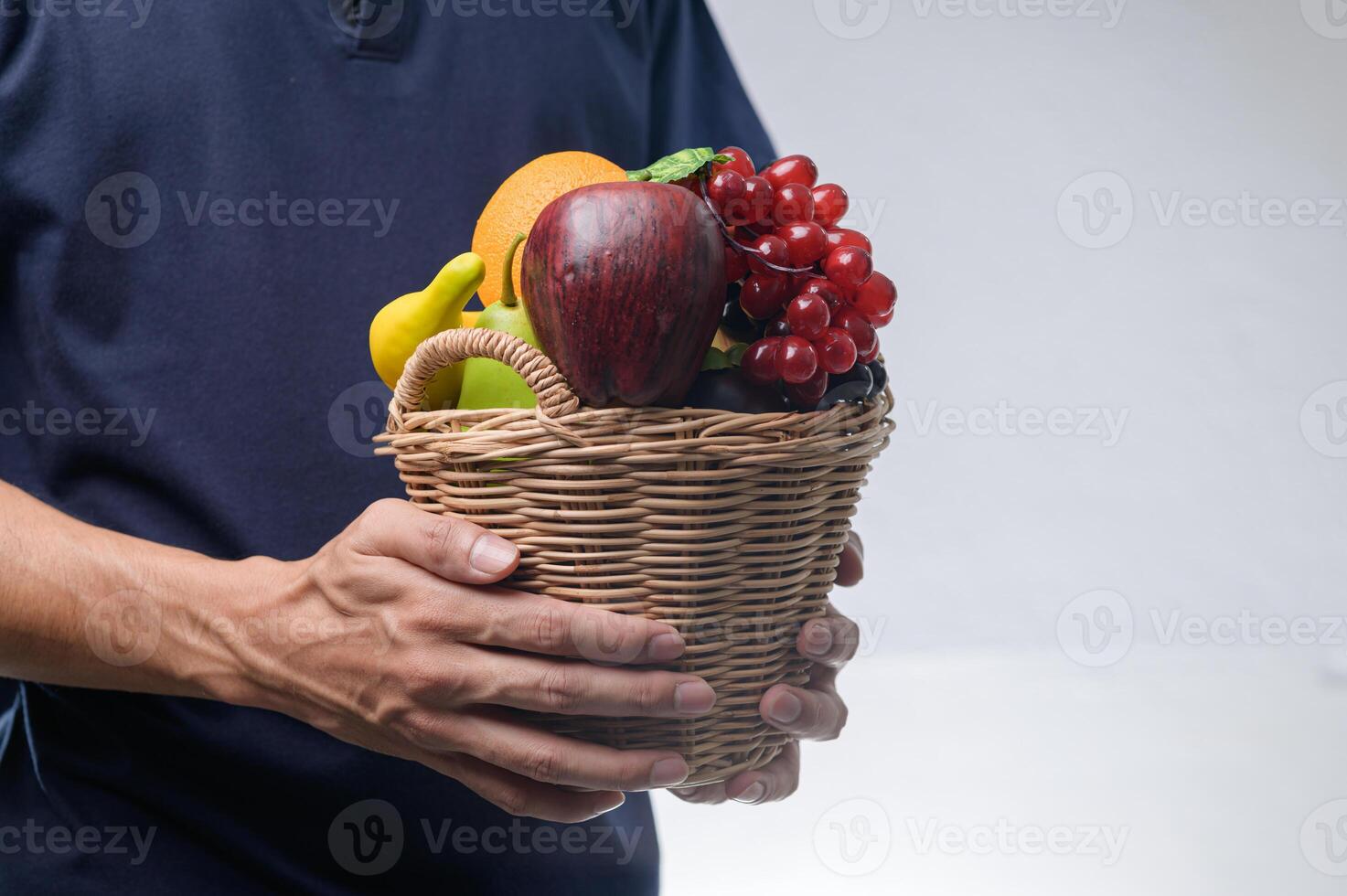 Fresh Fruit Basket Holding with Hands in Bright Background photo