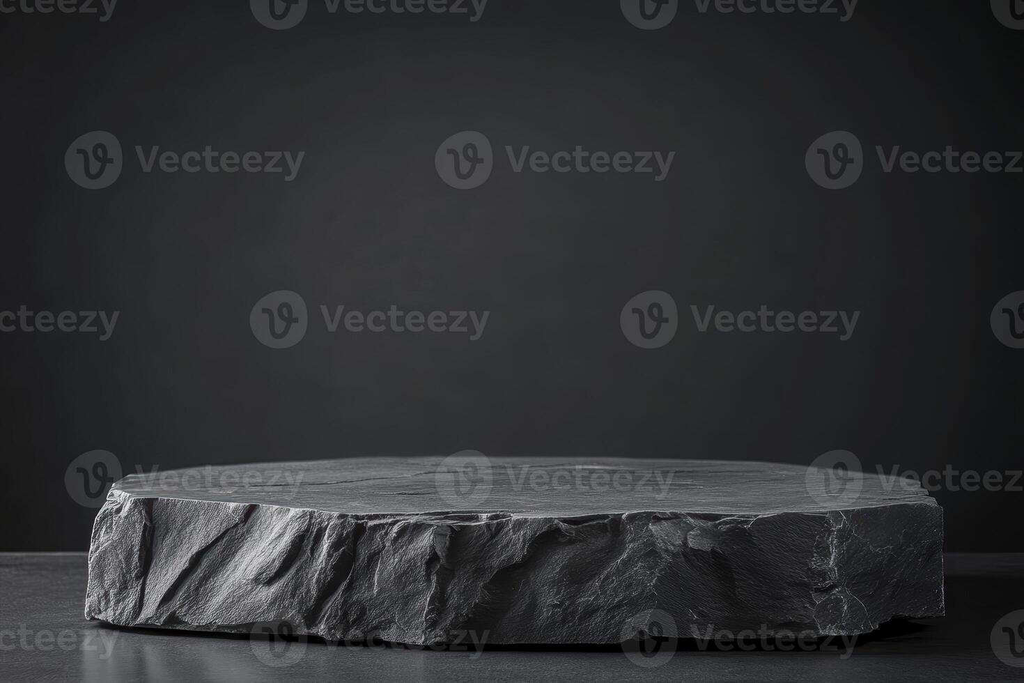 Dark textured stone platform on black background for product display photo