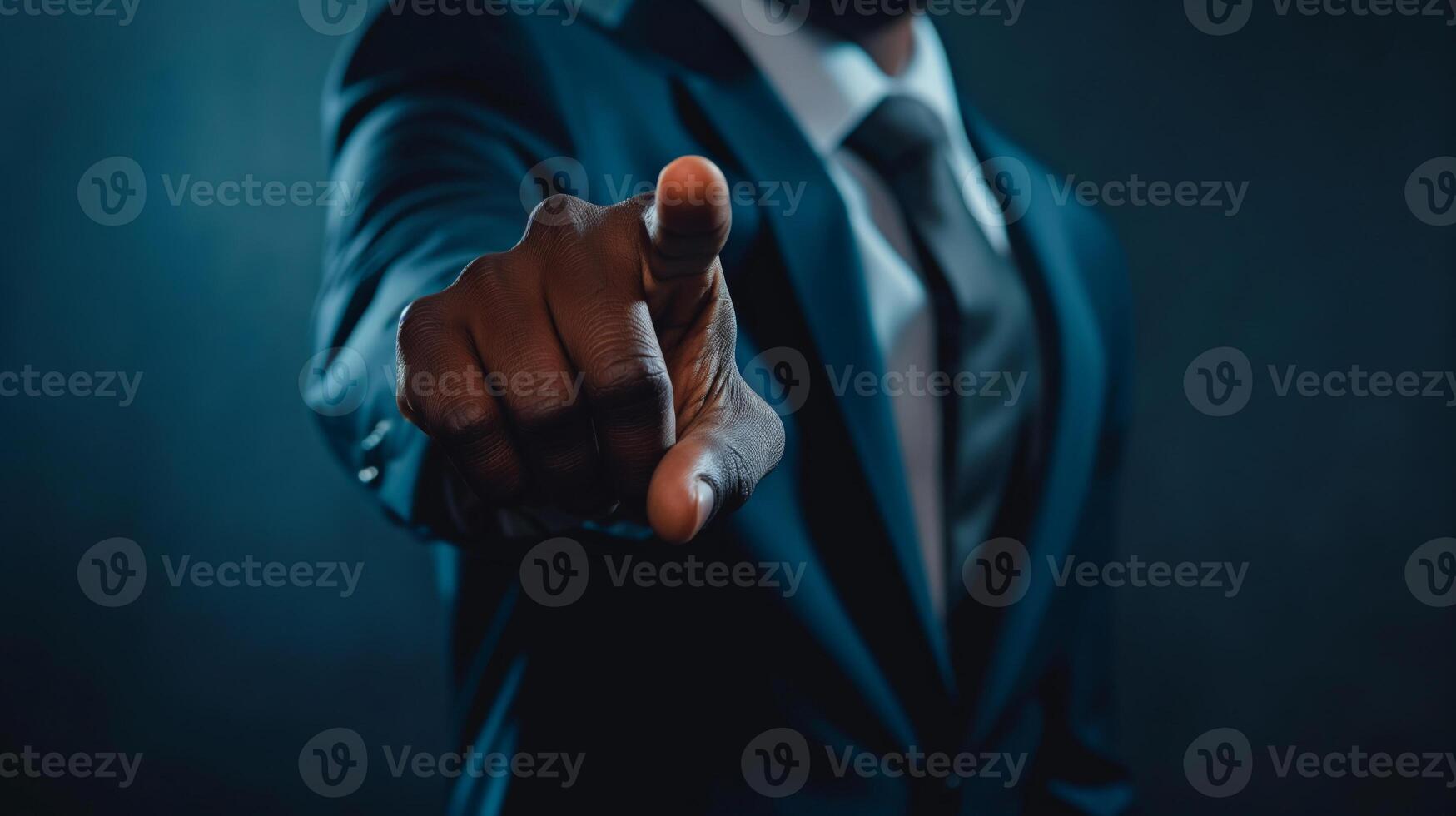 A man in a suit pointing at something photo