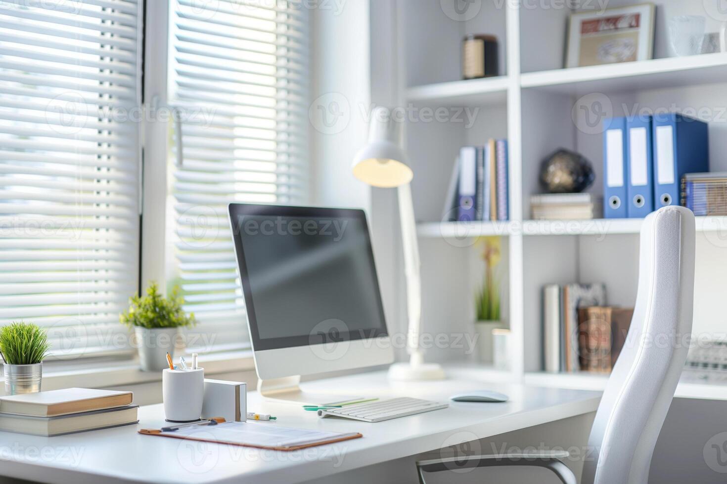 A white desk with a computer and a chair photo
