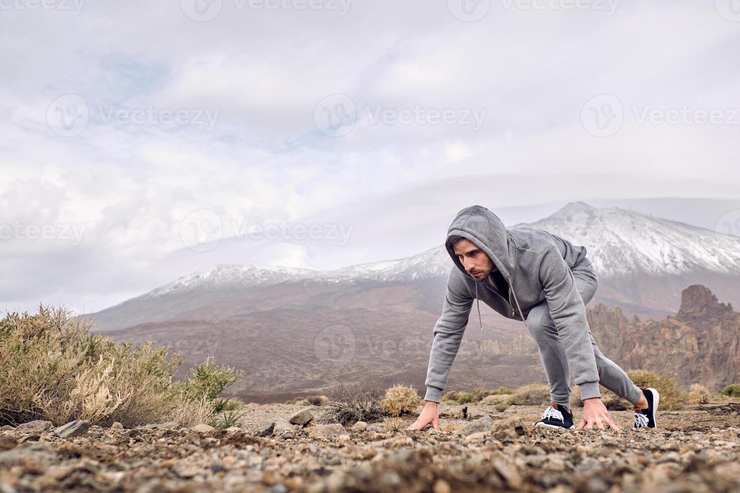Man getting ready for running in mountains photo