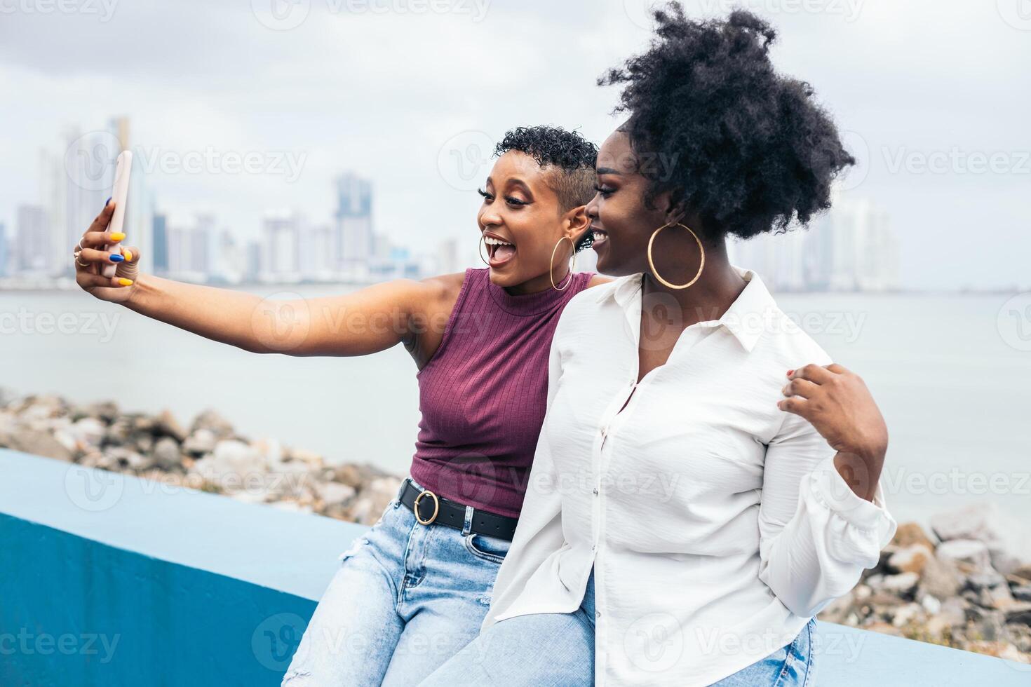 Stylish friends taking selfiesand having fun along the boardwalk in Panama City photo