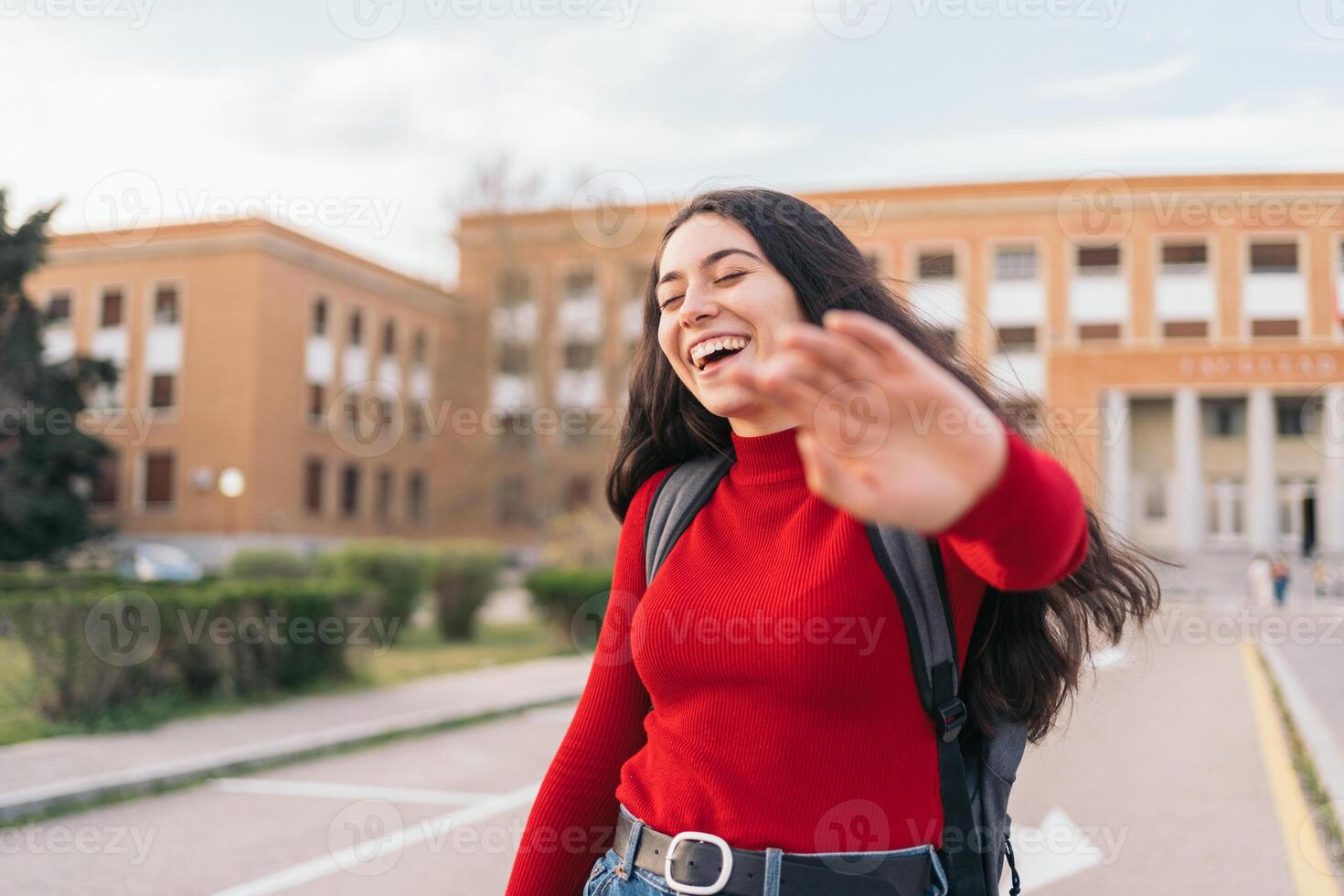 beauty student girl portrait laughing and covering her face with her hand photo