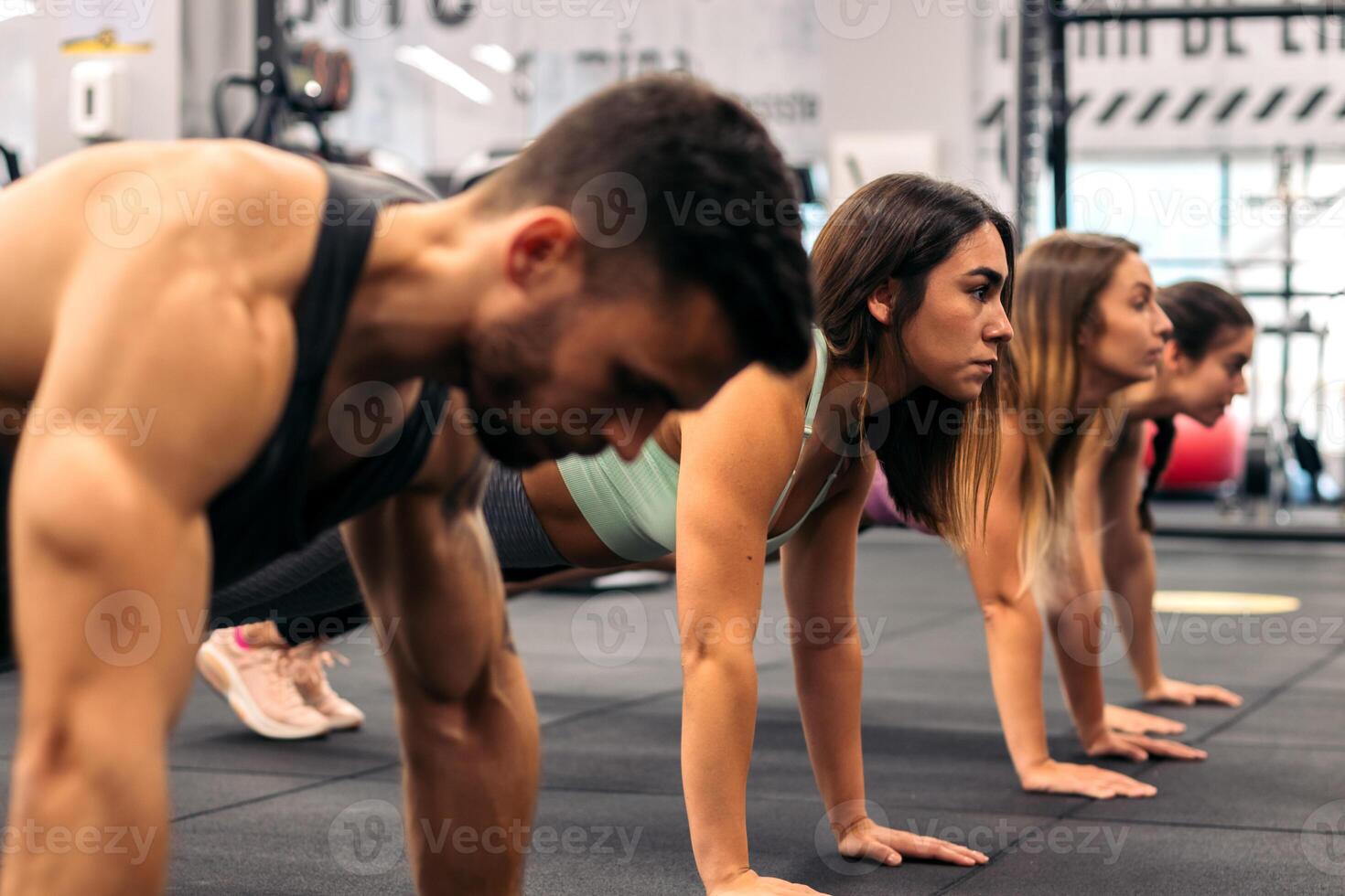 group of young people doing push ups in a gym. Fitness concept photo