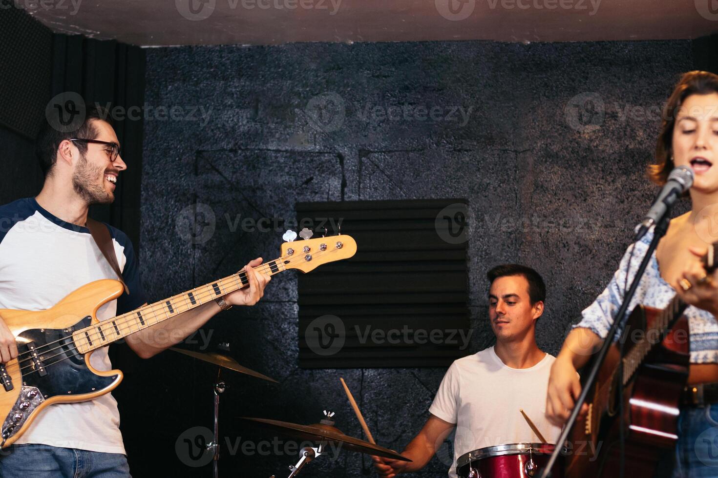 Music group rehearsing in a music venue. Singing photo