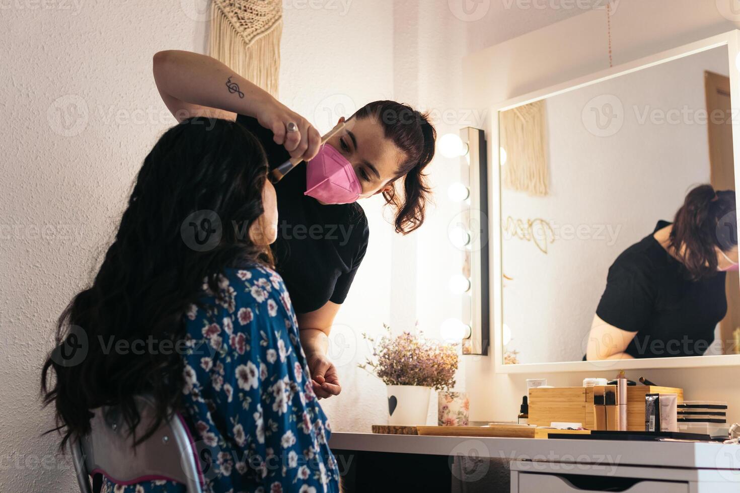 Bride being made up by a professional makeup artist. photo