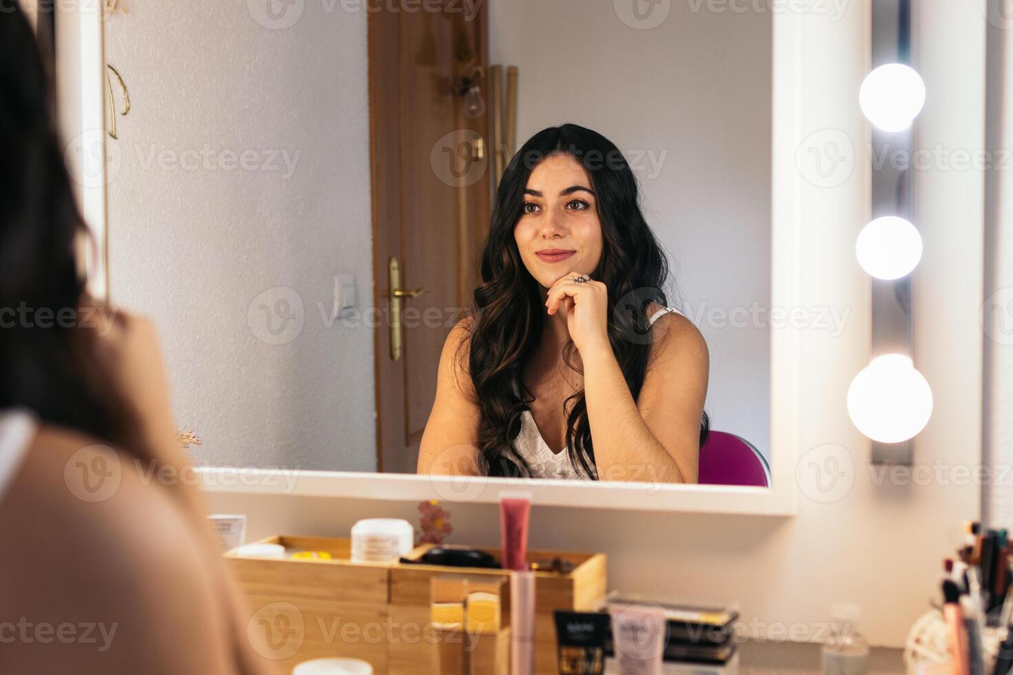 A bride smiling after having her make up and hair done photo