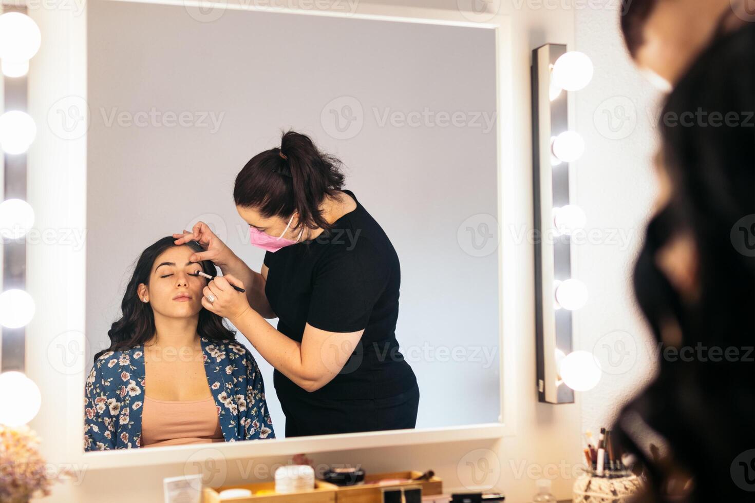 Professional makeup artist making up a young bride before the wedding photo