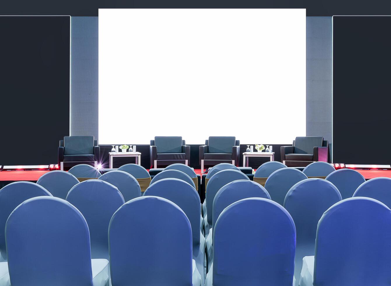 Four black armchair for speaker on stage and white screen display backdrop at business presentation exhibition photo