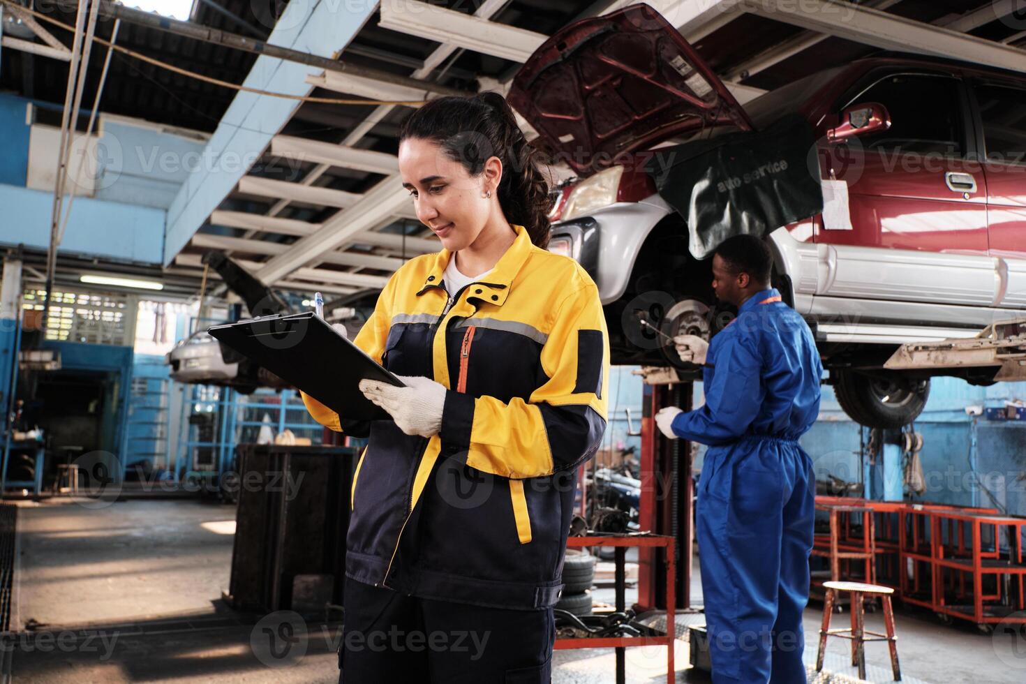 Hispanic female mechanic inspector, checklist service spare parts in maintenance work at a fix car garage station, professional engineer worker jobs in automotive and transportation industry business. photo