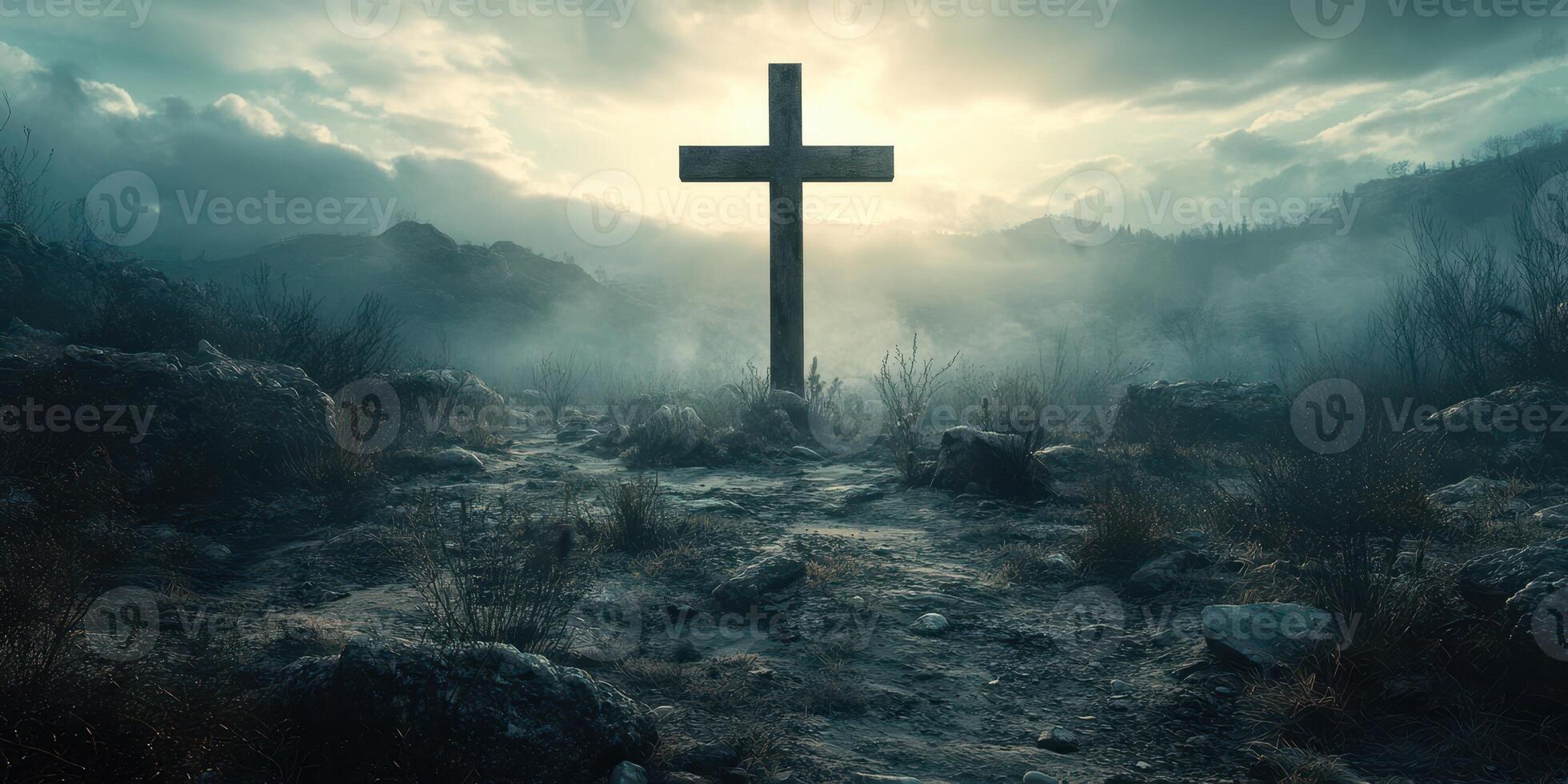 Cross stands in a misty landscape at dawn with a dramatic sky and rugged terrain surrounding it photo