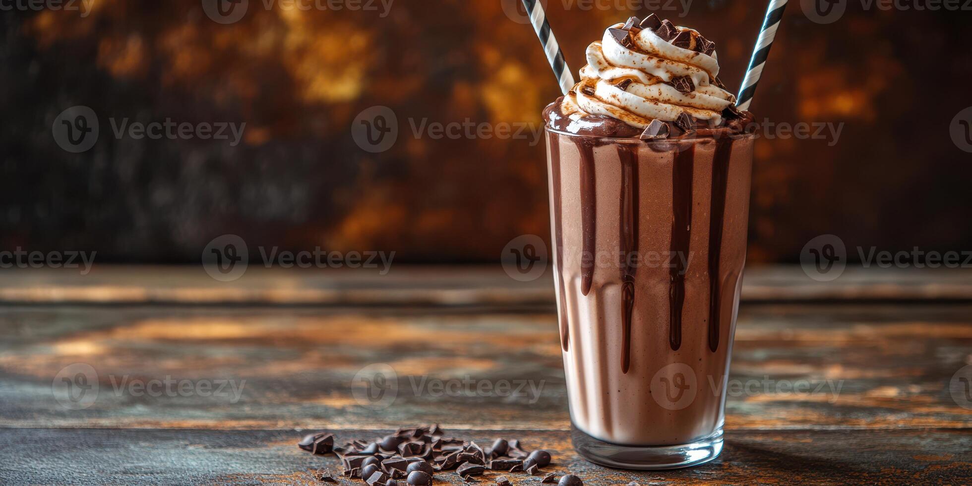 Creamy chocolate milkshake topped with whipped cream and chocolate shavings on a rustic wooden table photo
