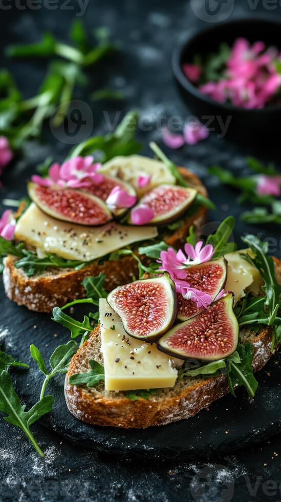 Delicious open-faced sandwich topped with figs, cheese, and flowers on a rustic table photo