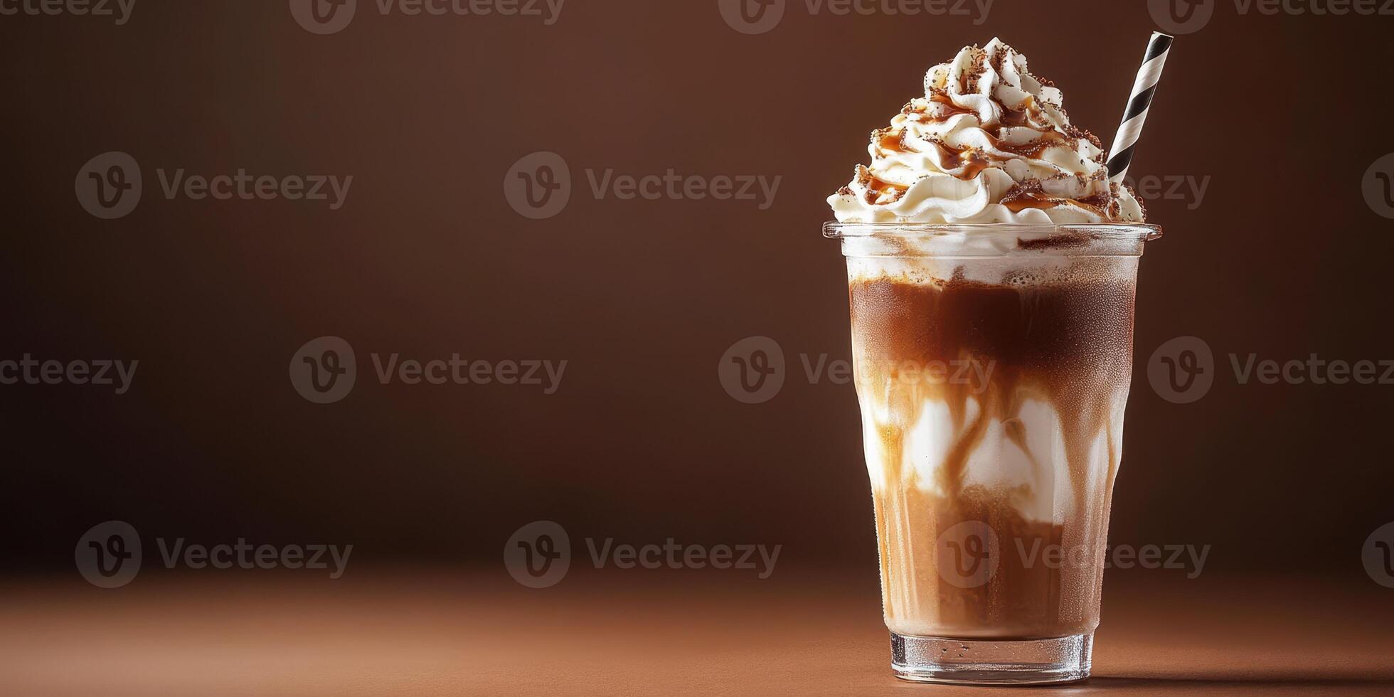 Delicious chocolate milkshake topped with whipped cream and chocolate drizzle served in a clear cup photo