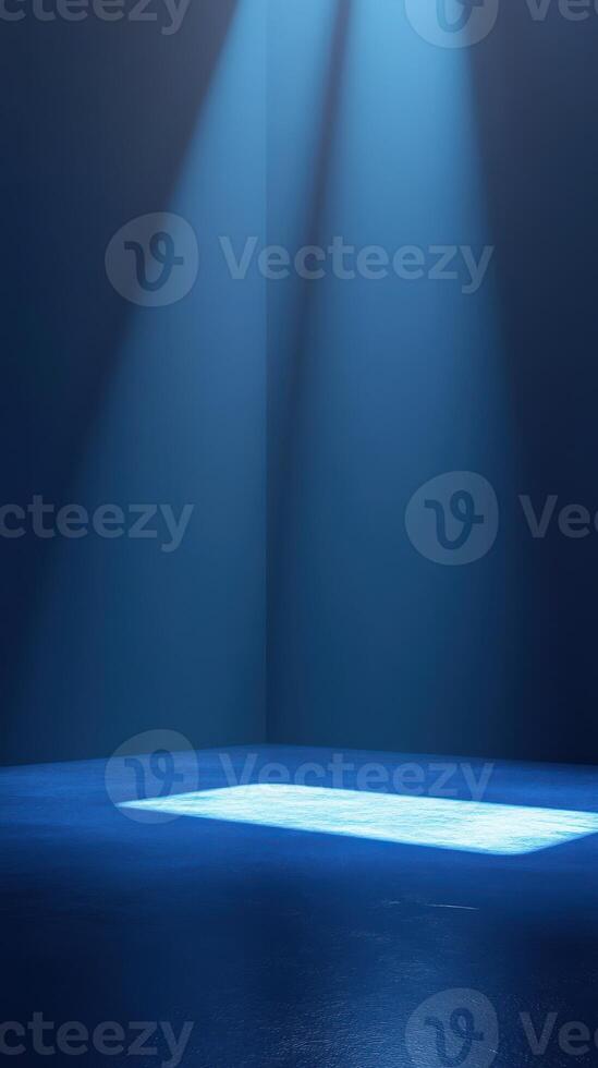 Bright blue spotlights illuminate an empty stage creating an atmosphere of anticipation and creativity in a dark room photo