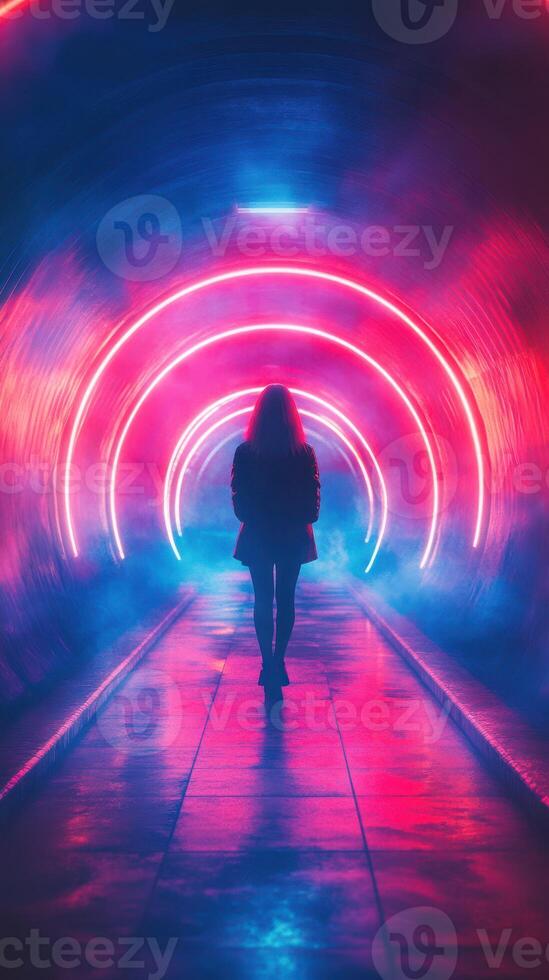 Woman walking through a neon-lit tunnel with colorful lights and fog at night photo