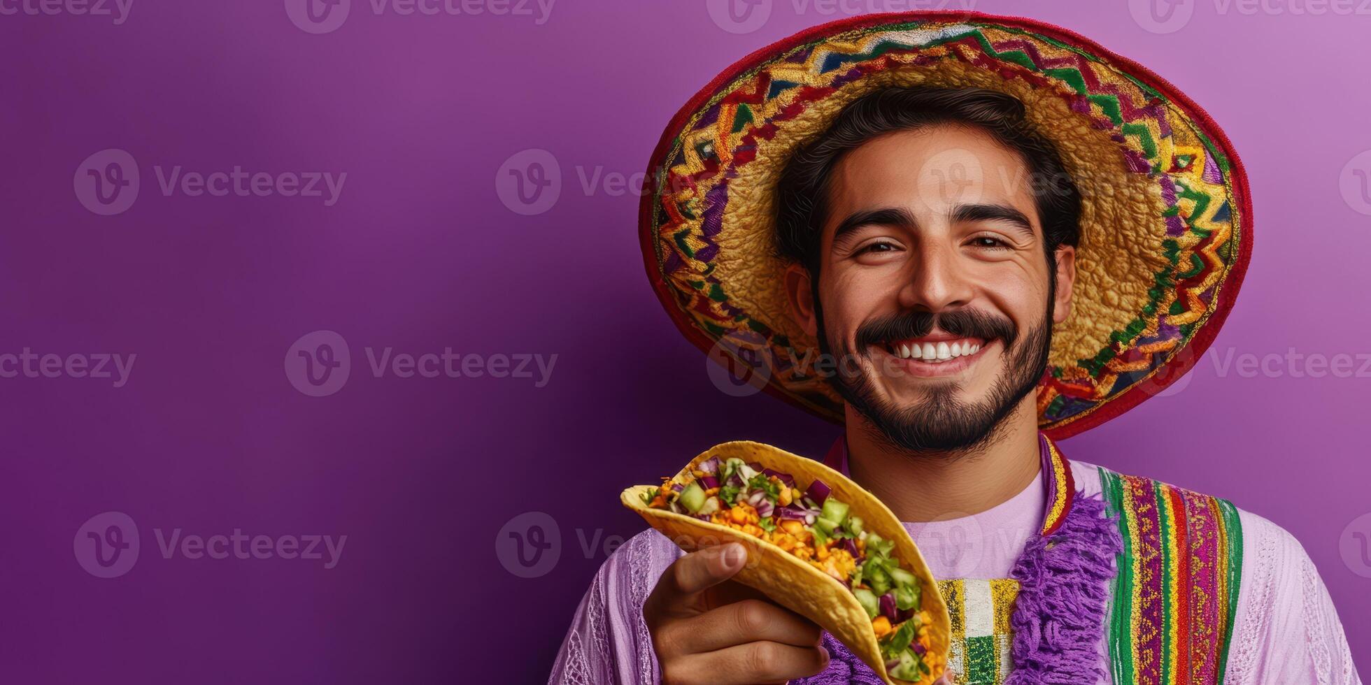 Smiling man in colorful attire holding a taco against a vibrant purple background during a food festival in a lively setting photo