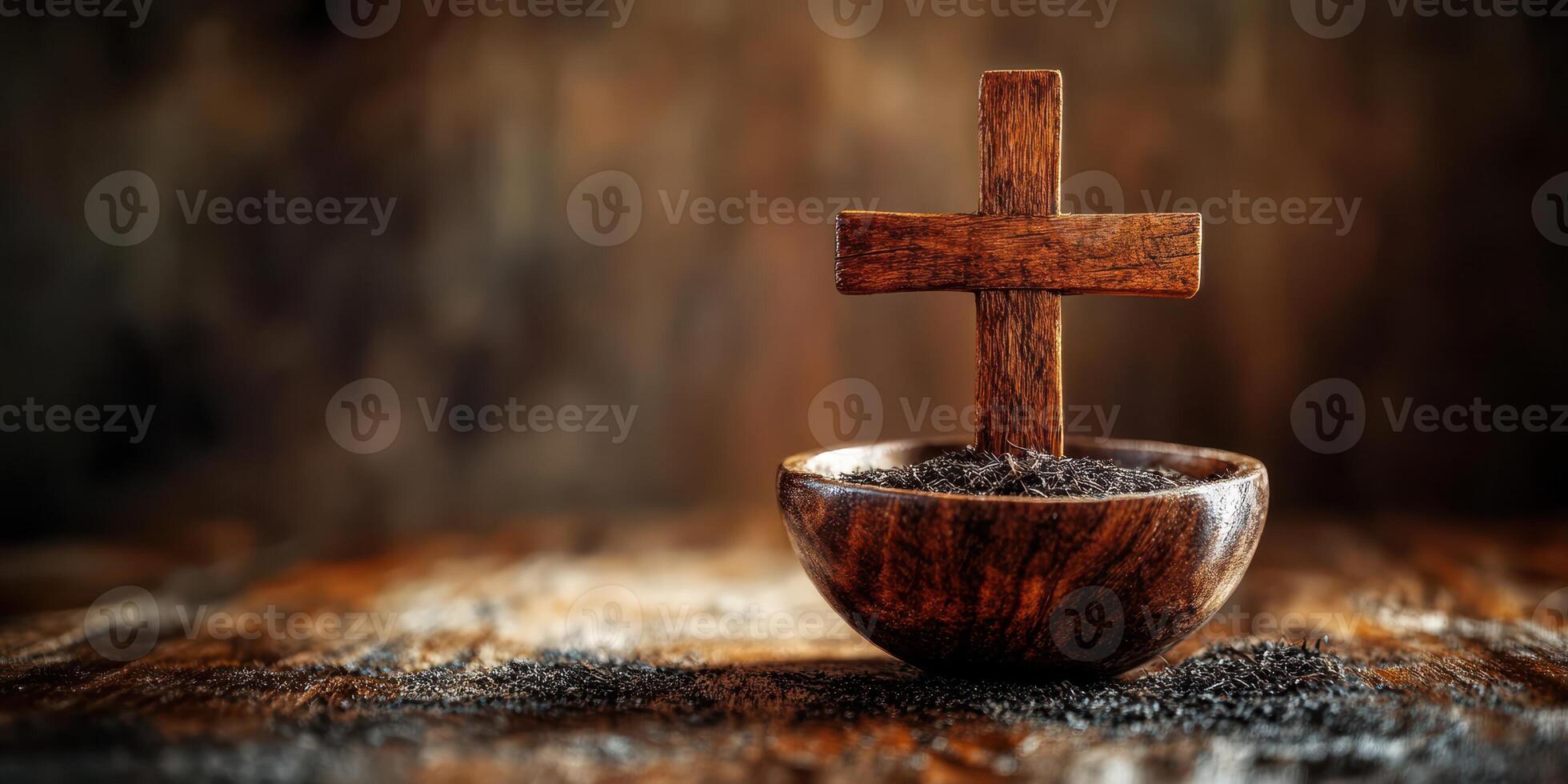 Wooden cross placed in a rustic bowl with soil on a textured wooden surface photo