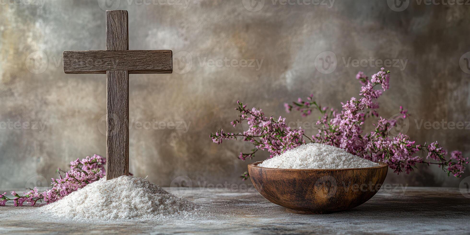Cross and bowl of salt with flowers on weathered surface during serene setting photo